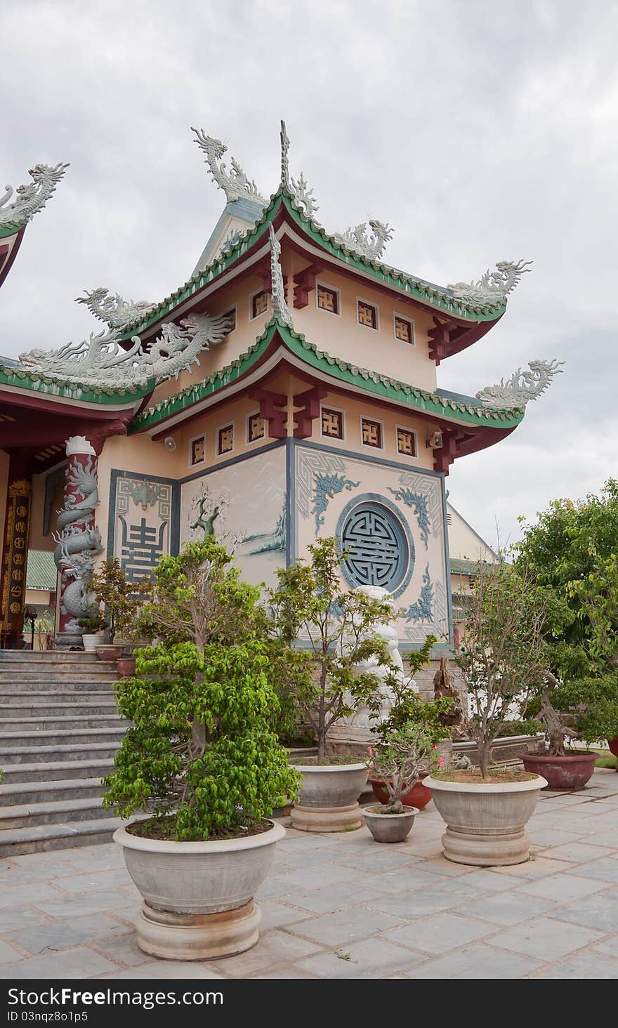 A part of a Buddhist temple ornamented with religious symbols and exquisite roof. A part of a Buddhist temple ornamented with religious symbols and exquisite roof.