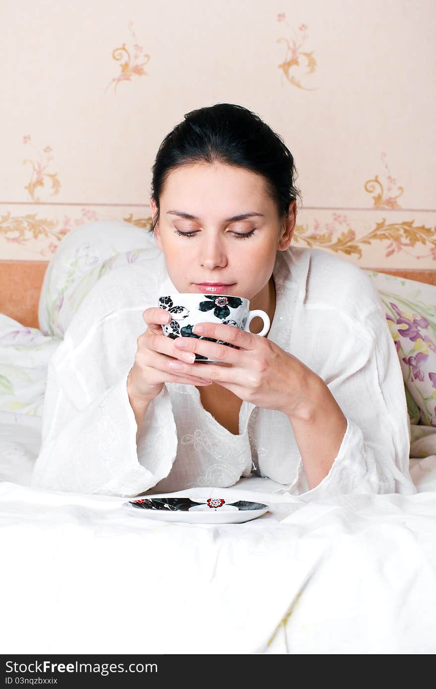 A young woman holding a cup of coffee