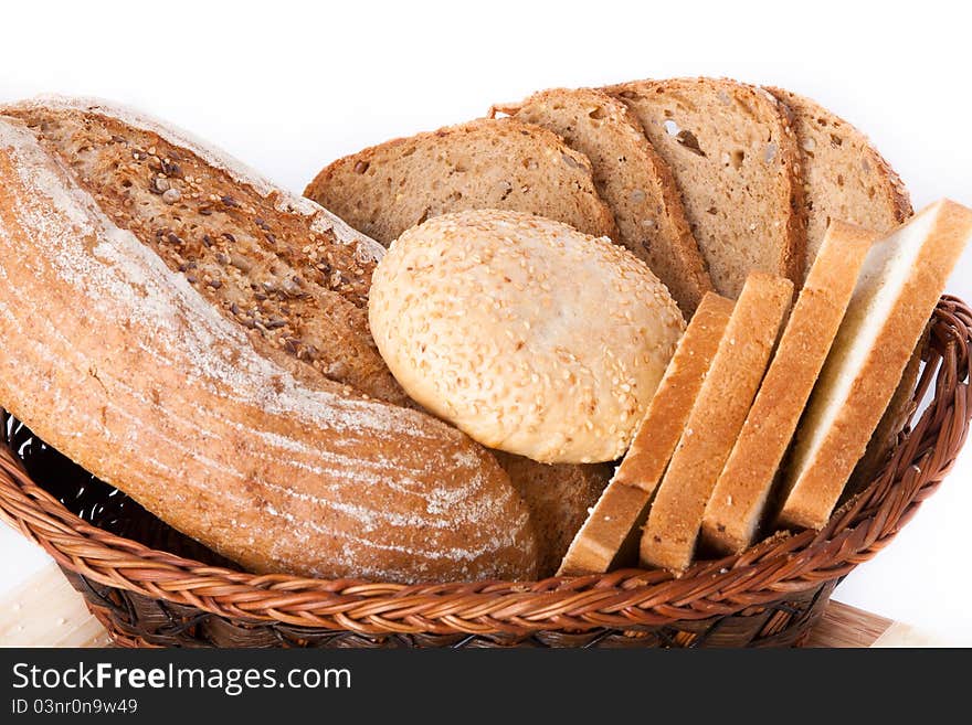 Various bakery products in a basket over white