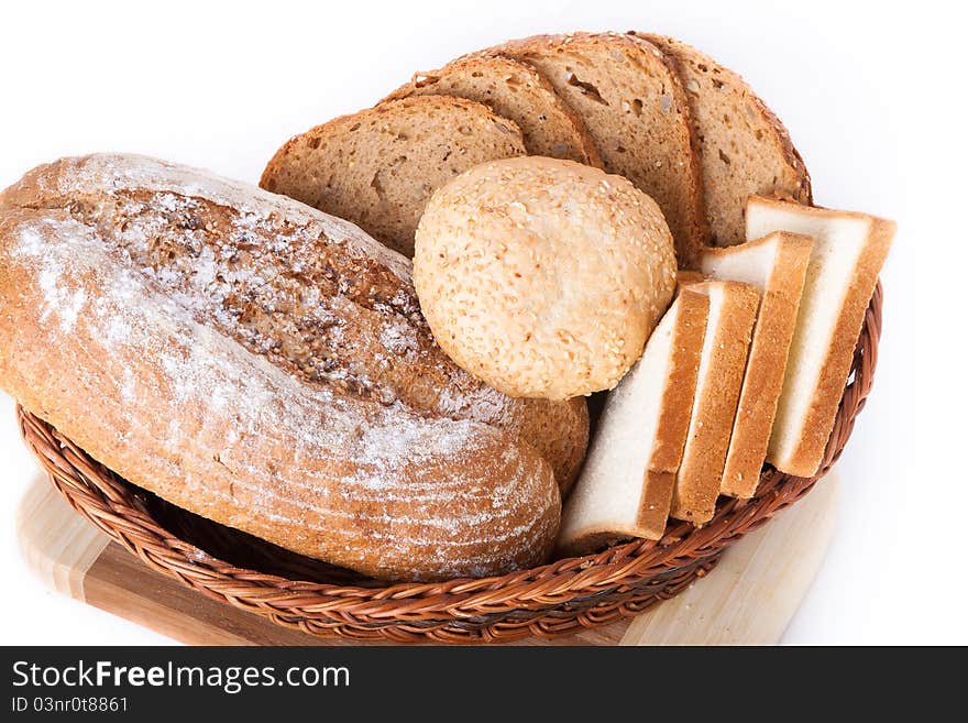 Various bakery products in a basket over white