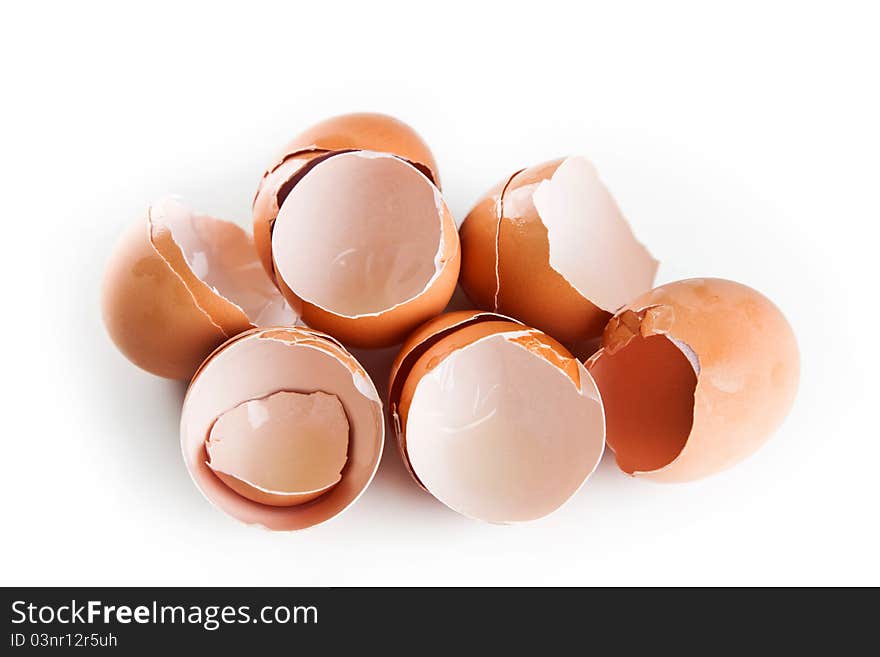 The brown eggshells in the white kitchen table