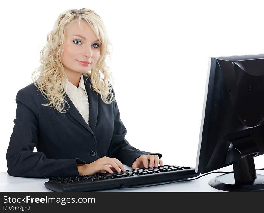 The young girl behind the computer on white