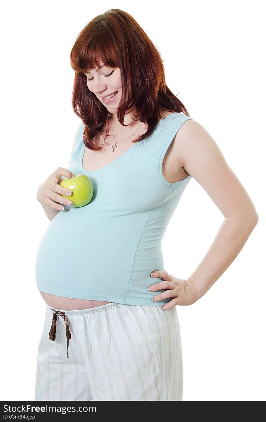 The pregnant woman with an apple on white