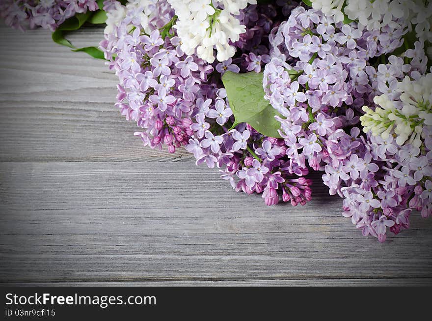 The beautiful lilac on a wooden surface