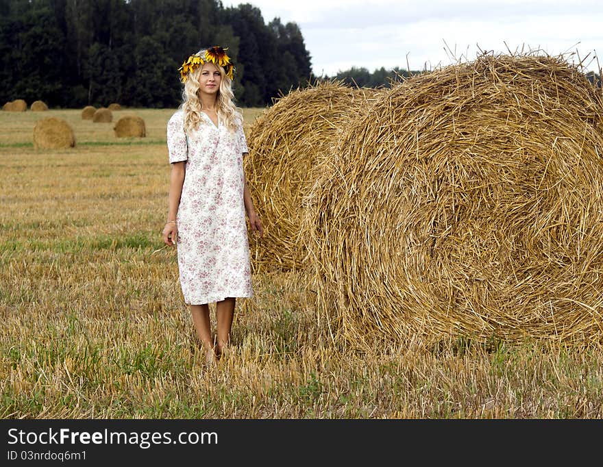 Beautiful girl in chaplet on nature. Beautiful girl in chaplet on nature