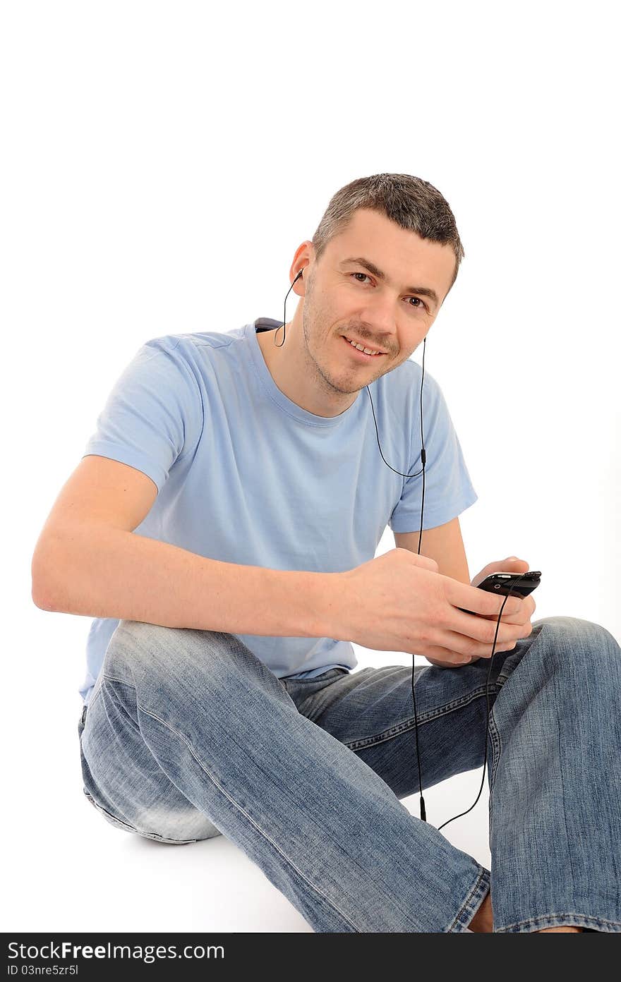 Casual Young Man With Cell Phone And Headphones