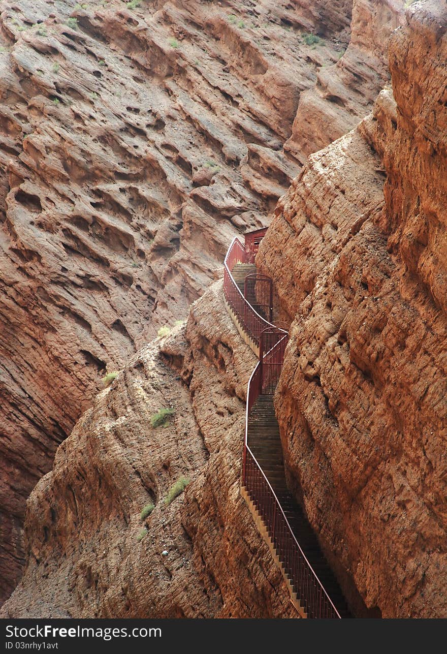 It's karst mountains in xinjiang region, there is a step road around sharp cliff. It's karst mountains in xinjiang region, there is a step road around sharp cliff