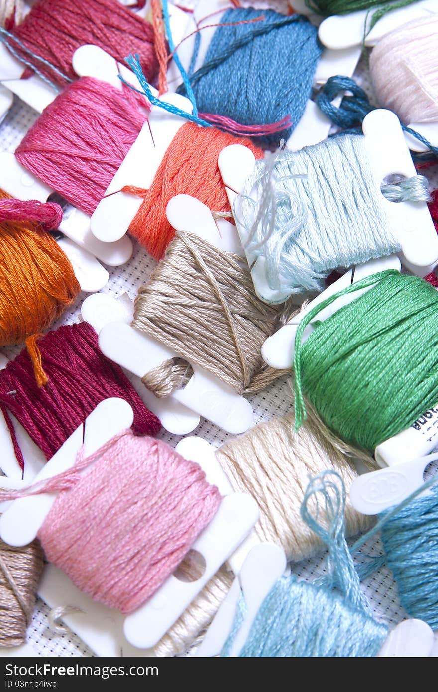 Pile Of Coloured Bobbins Of Thread