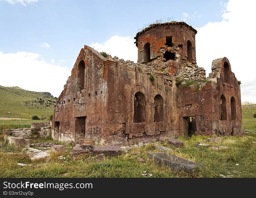 Landscape ruins of dilapidated and derelict Old Red Church Kizil Kilsie Cappadocia Turkey dating to the 6th century, red limestone, horizontal, crop area and copy space. Landscape ruins of dilapidated and derelict Old Red Church Kizil Kilsie Cappadocia Turkey dating to the 6th century, red limestone, horizontal, crop area and copy space