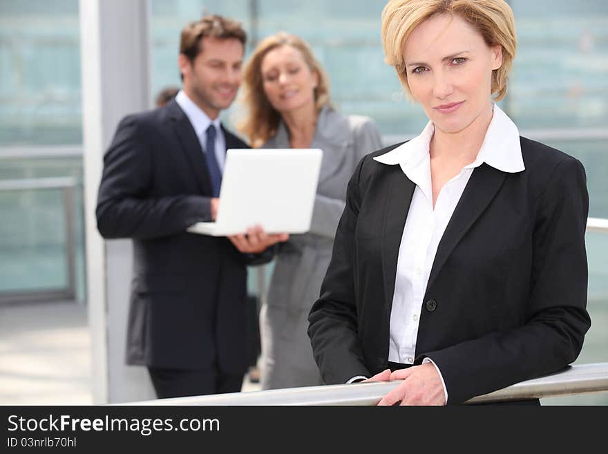 Beautiful businesswoman portrait wearing black suit over white. Beautiful businesswoman portrait wearing black suit over white