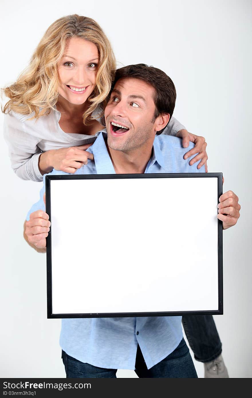 Enthusiastic couple with white board