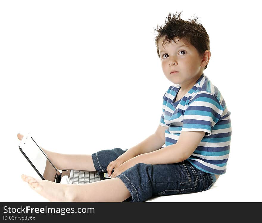 Lovely child isolated on a white background with a laptop. Lovely child isolated on a white background with a laptop