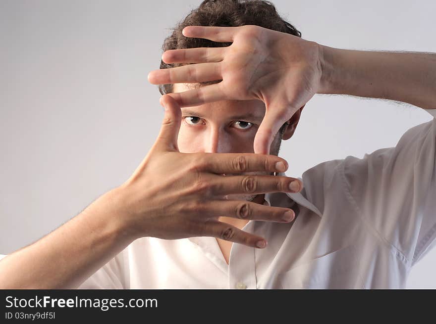 Young man making a frame with his hands. Young man making a frame with his hands