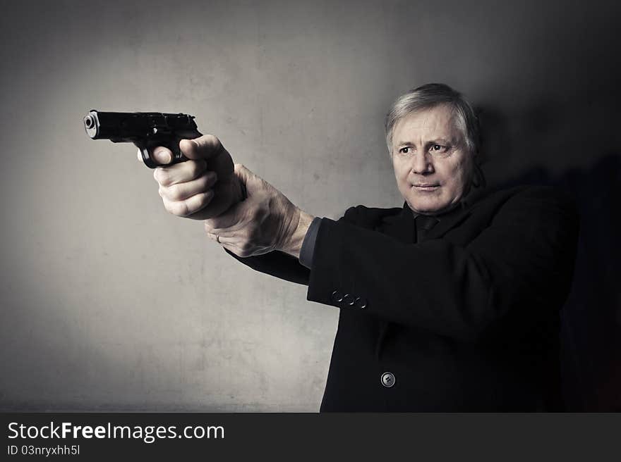 Portrait of a senior man holding a gun. Portrait of a senior man holding a gun