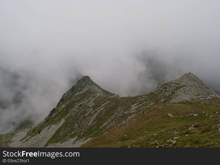 Path and hikers on the ridge of a mountain in Transylvania. Path and hikers on the ridge of a mountain in Transylvania