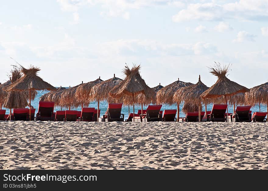 View of the beach with loungers and umbrellas. View of the beach with loungers and umbrellas.