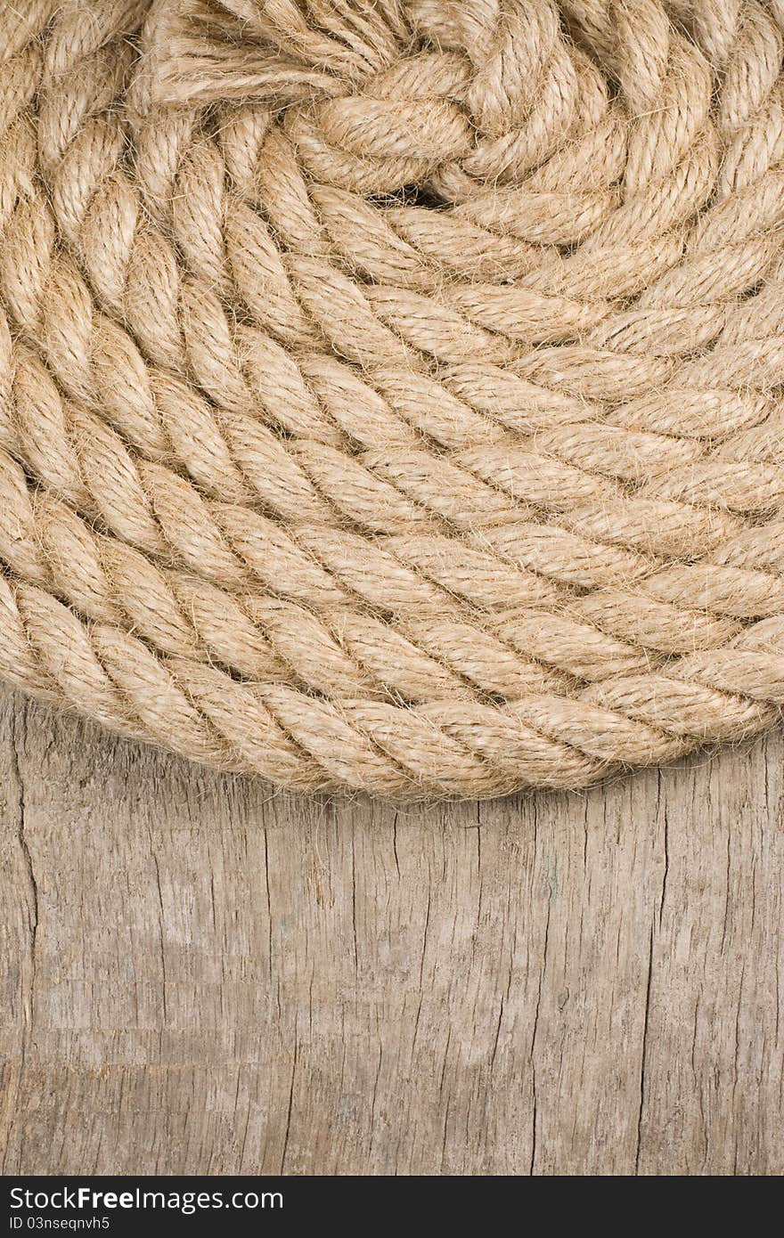 Ship ropes and knot on wood background texture. Ship ropes and knot on wood background texture