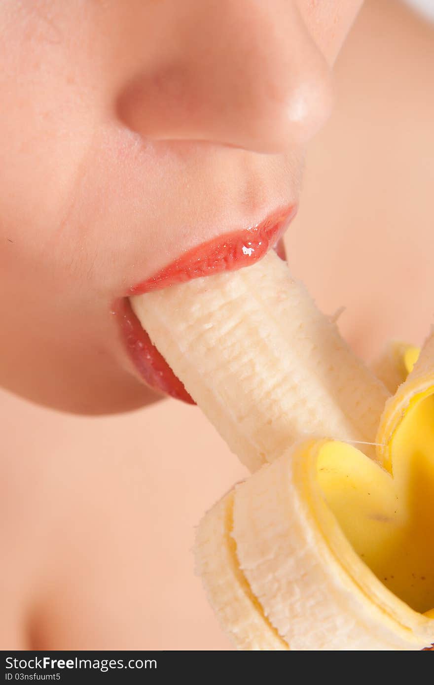 Young woman eating banana