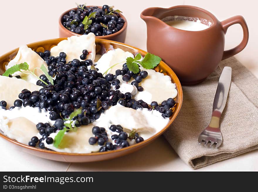 Sweet and delicious dumplings with cottage cheese, sour cream and berries. Sweet and delicious dumplings with cottage cheese, sour cream and berries