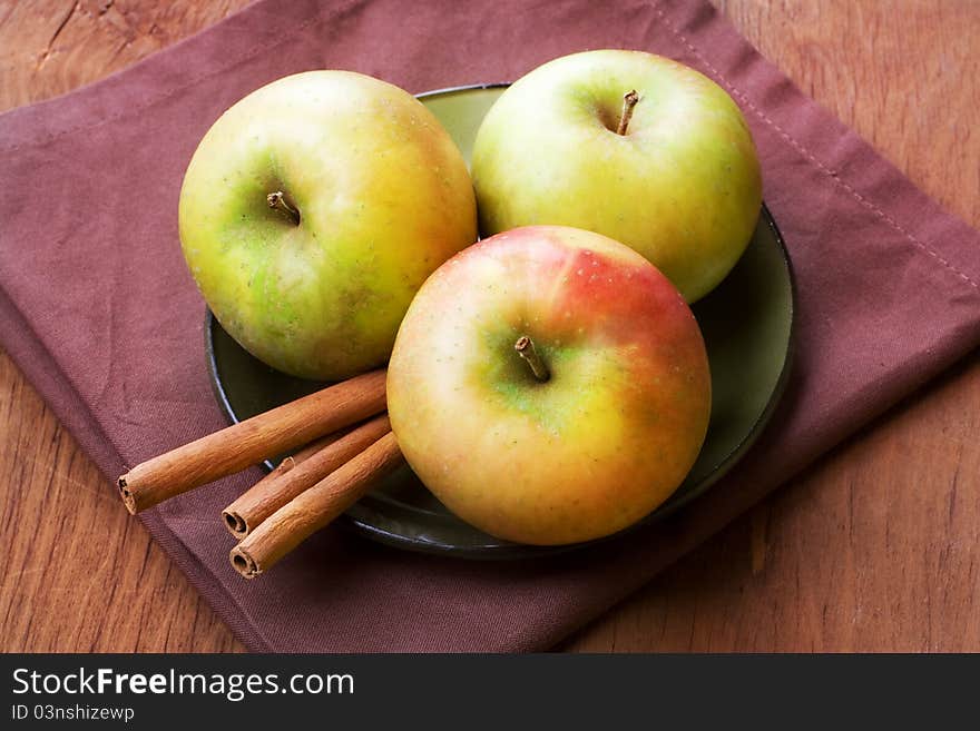 Apples and cinnamon sticks on table, still life. Apples and cinnamon sticks on table, still life.