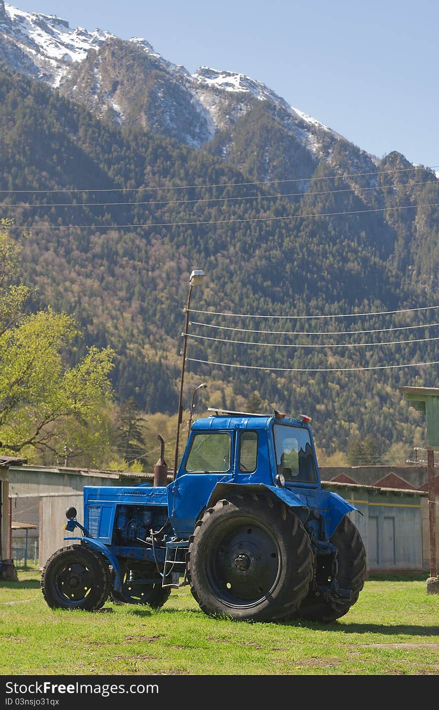 Blue tractor in the background of the mountains