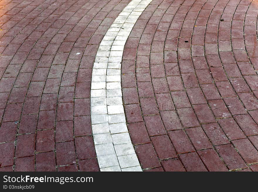 Ground mosaic at the outdoor with white and light maroon colored pattern. Ground mosaic at the outdoor with white and light maroon colored pattern