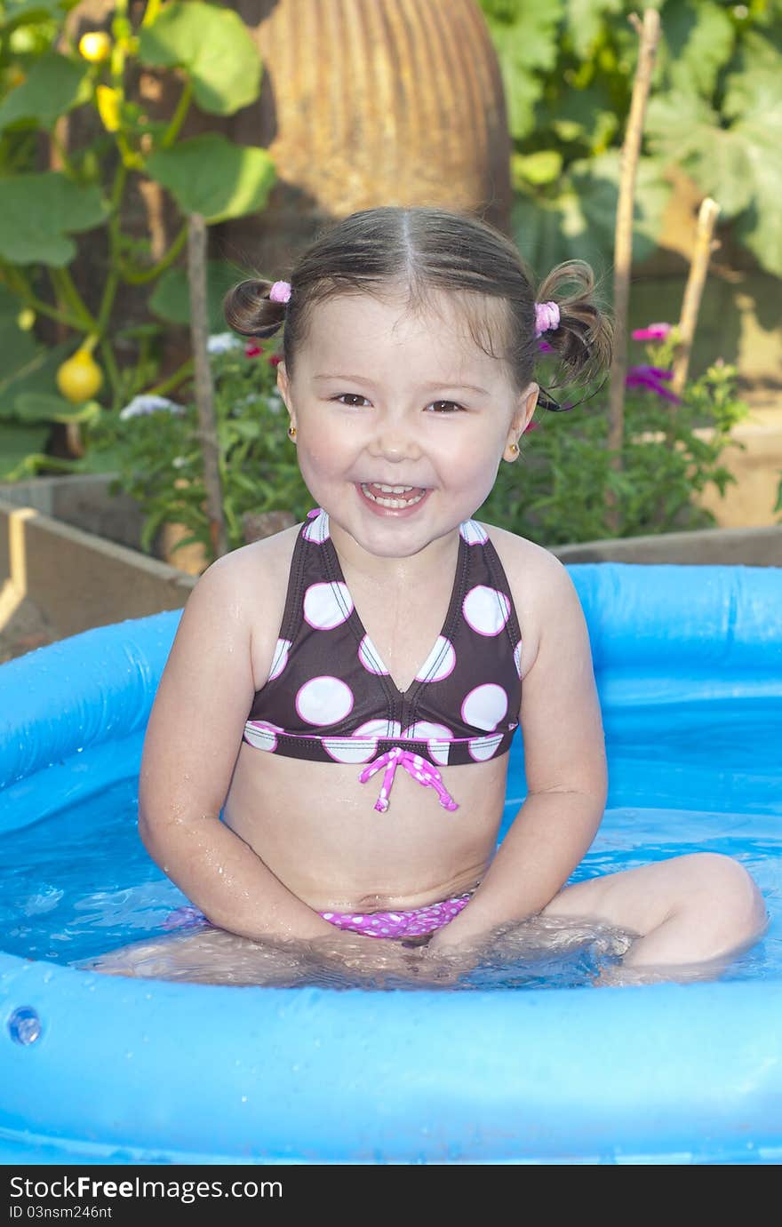 Happy Little Girl In A Swimming Pool