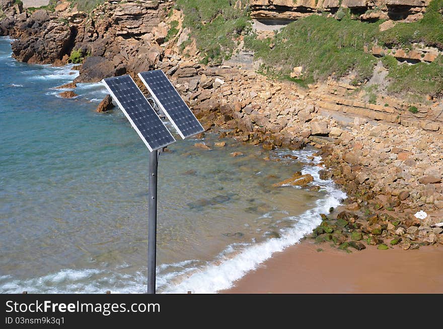 An streetlight with solar panel against coast background