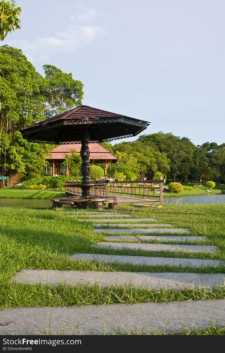 Stone walkway and wooden bridge in garden