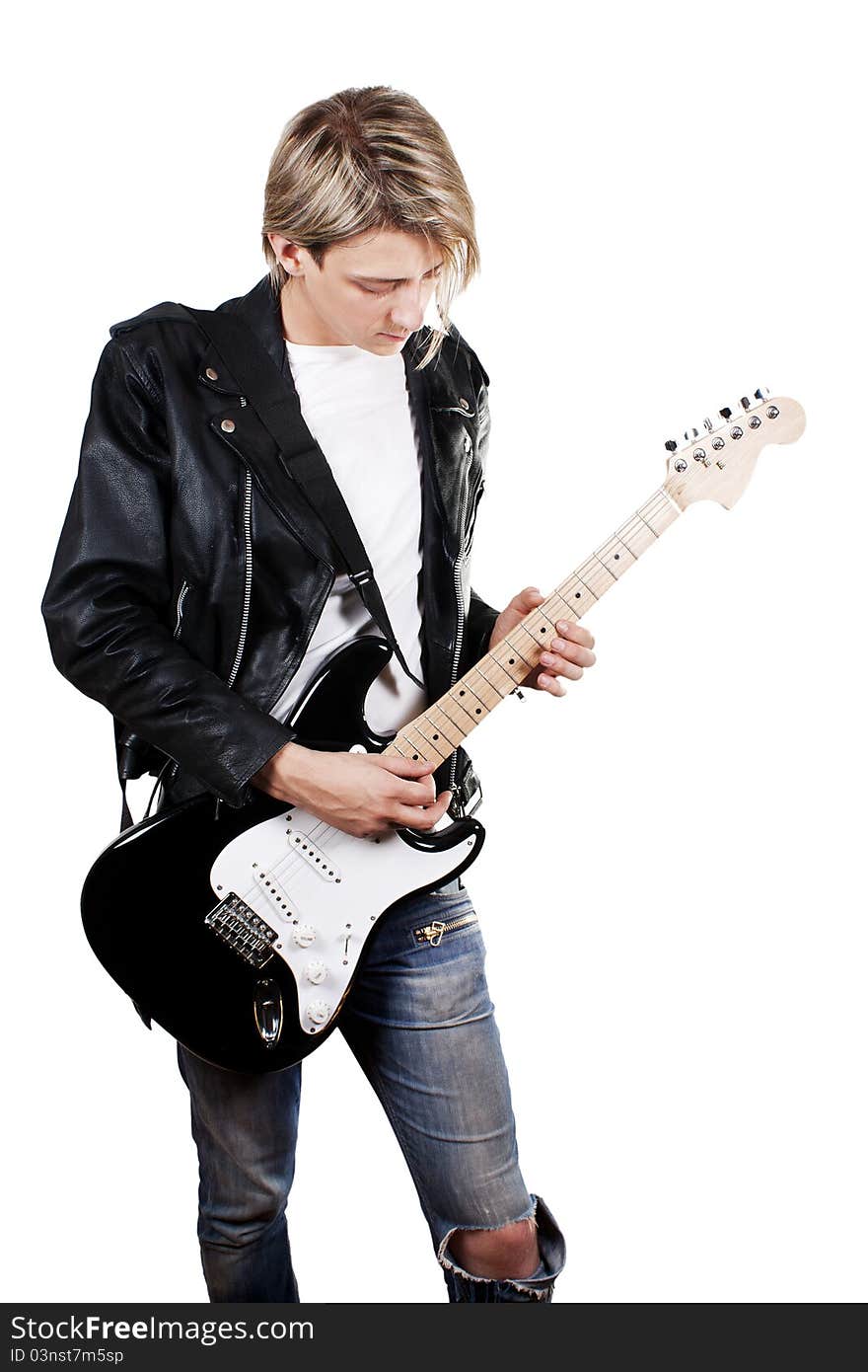 Young guy in leather jacket playing electric guitar