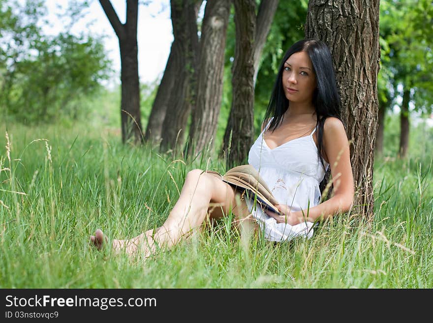 Girl reading book in the park