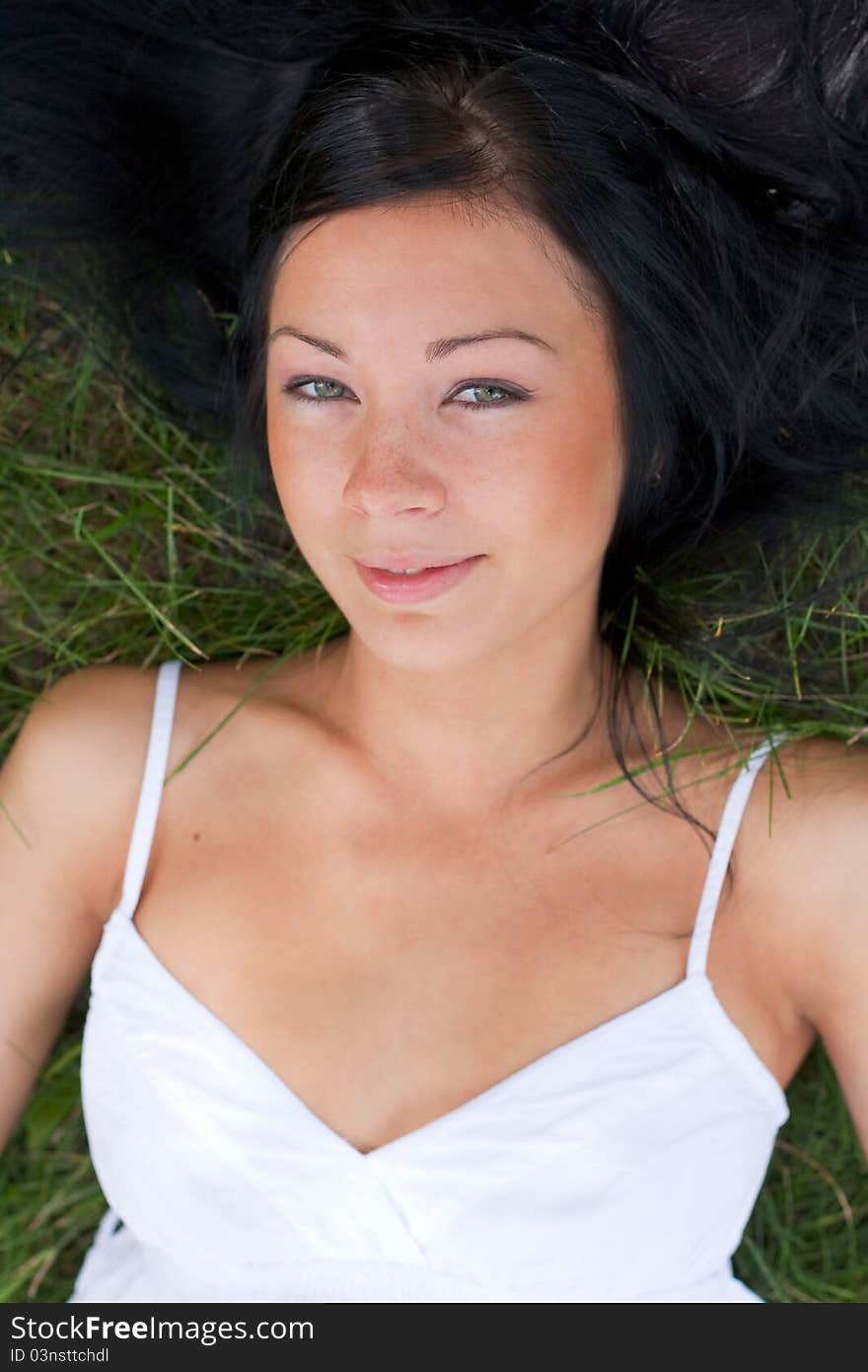 Portrait of a girl lying on the green grass. Portrait of a girl lying on the green grass