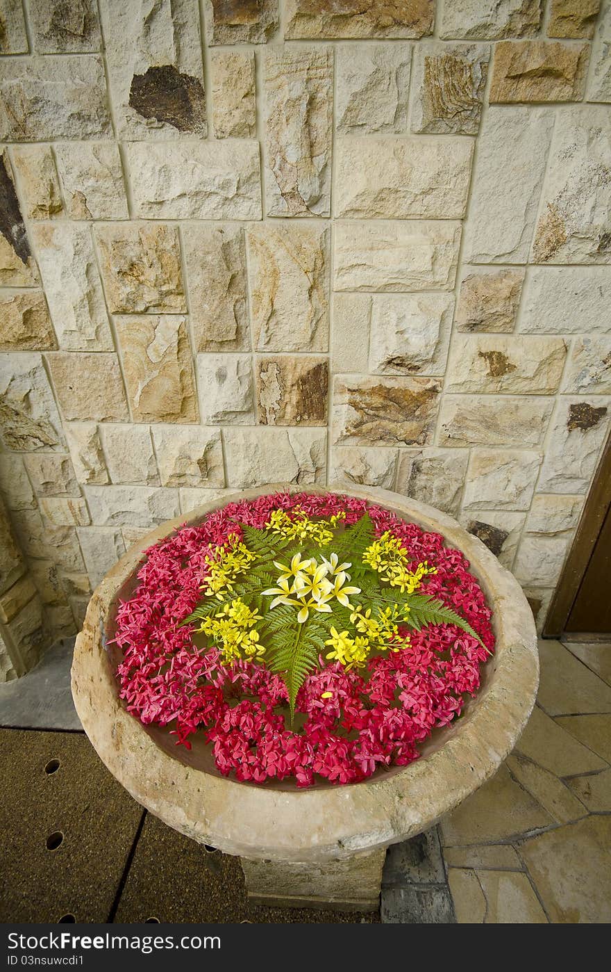 Water fountain that full of flower with stone wall background. Water fountain that full of flower with stone wall background