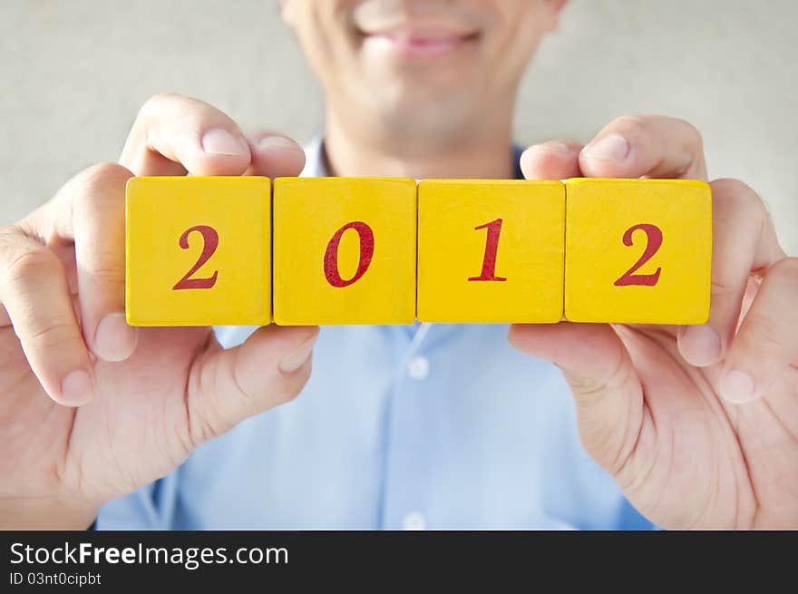 Salesman holding building blocks, building blocks that read 2012, Representatives for the 2012 years. Salesman holding building blocks, building blocks that read 2012, Representatives for the 2012 years