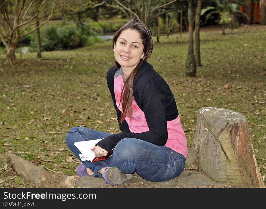 Pritty girl sat on long with book. Pritty girl sat on long with book