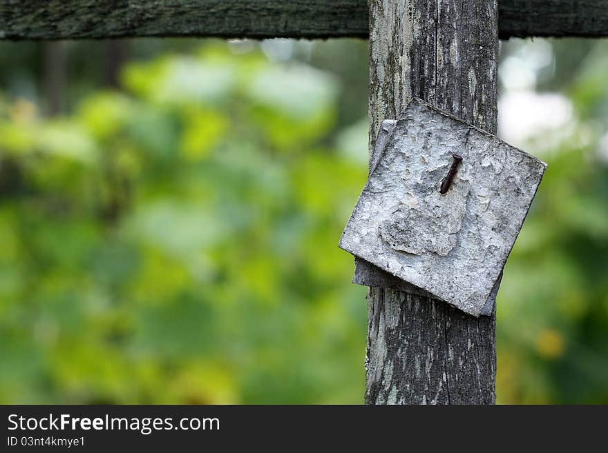 Blank sign nailed to a wooden board in garden. Blank sign nailed to a wooden board in garden