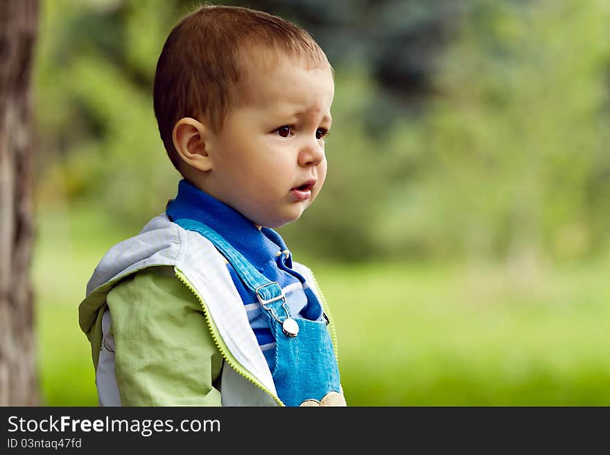 Baby boy in blue in park