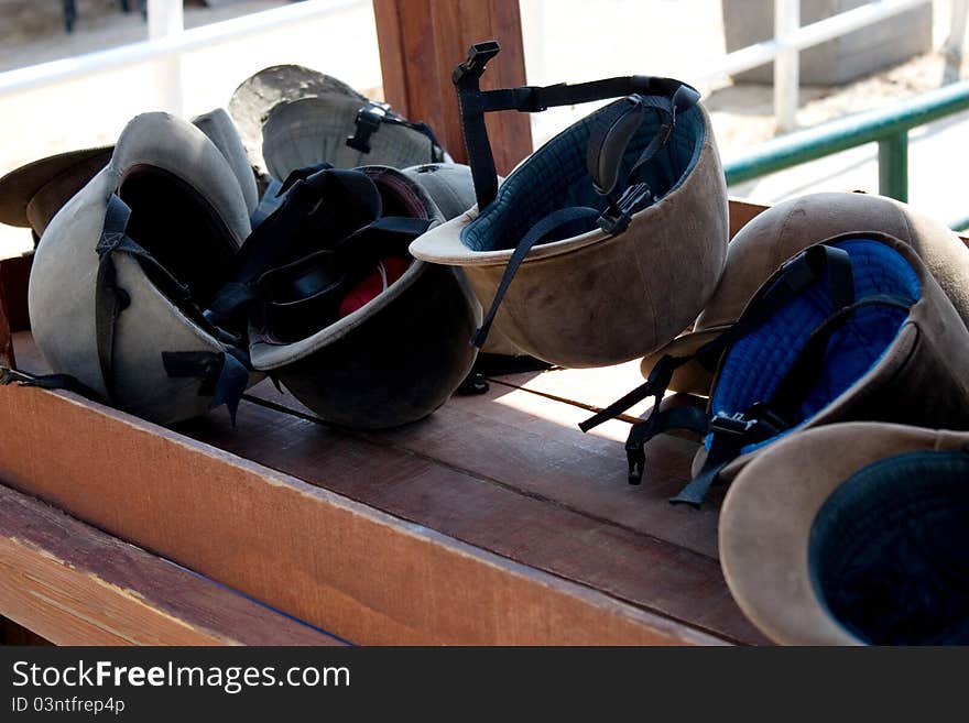 Riding helmets on wood table. Riding helmets on wood table.