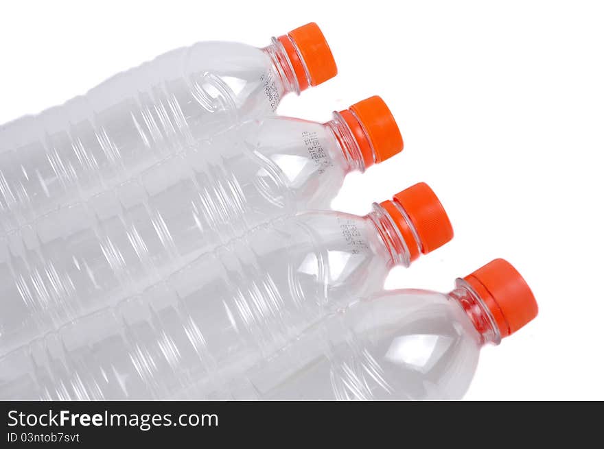 Four closed plastic bottles isolated on white background