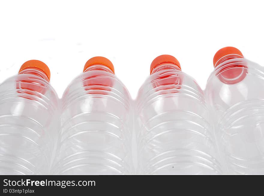 Four closed plastic bottles isolated on white background