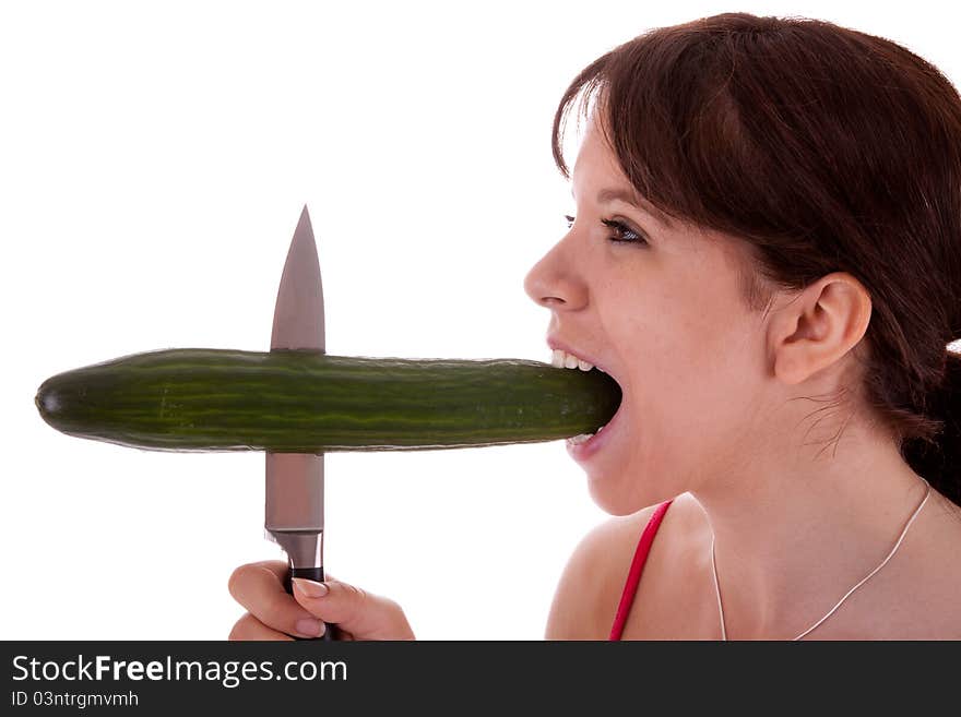 The pretty young woman has impaled a cucumber. The pretty young woman has impaled a cucumber