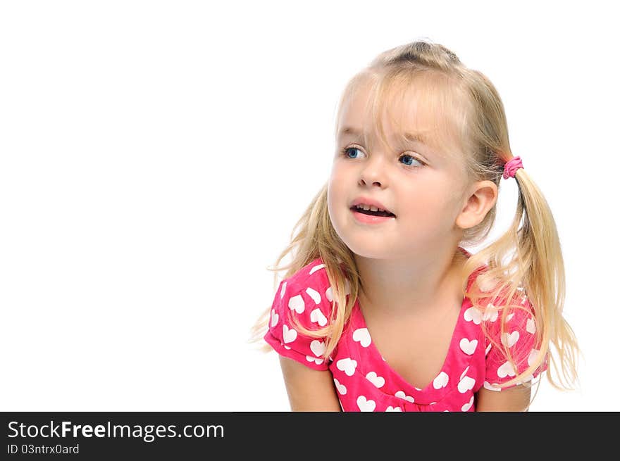 Adorable young girl with pigtails and blond hair looks to her right in studio, isolated on white. Adorable young girl with pigtails and blond hair looks to her right in studio, isolated on white.