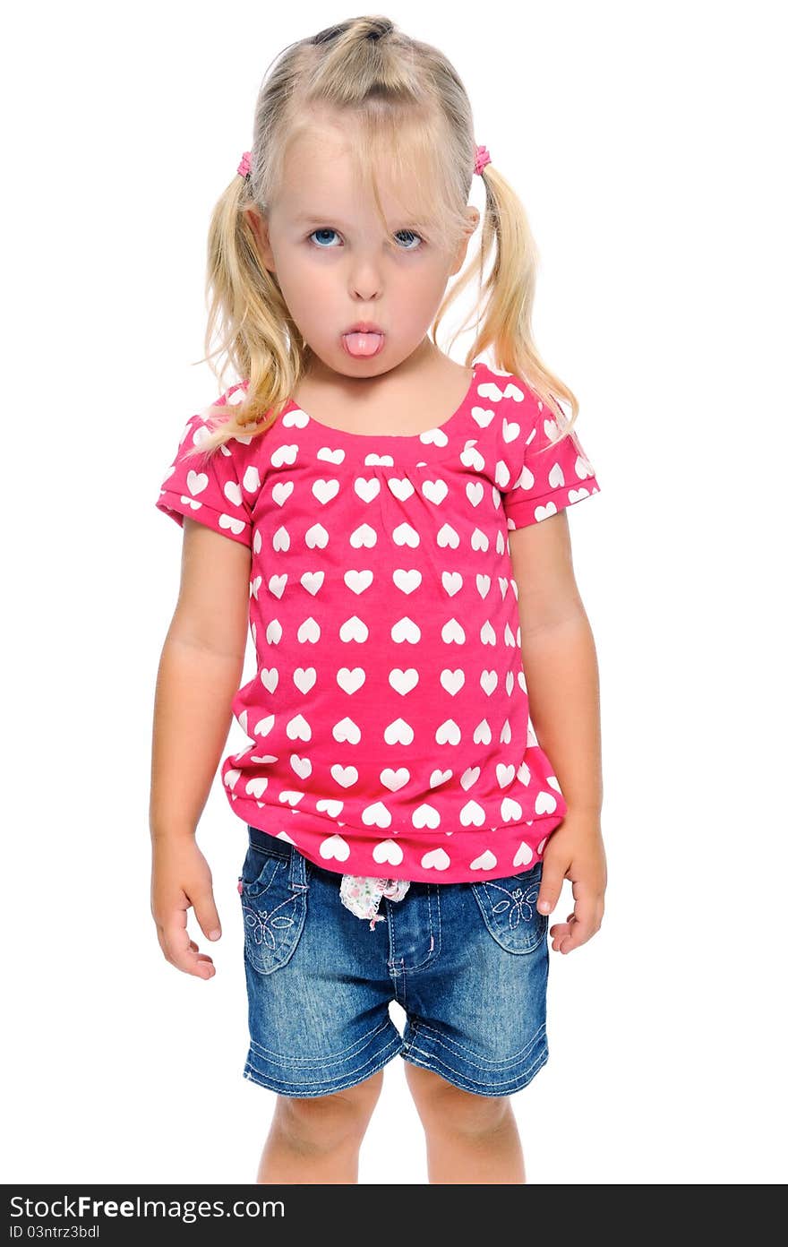 Young girl sticks out tongue while isolated on white in studio. Young girl sticks out tongue while isolated on white in studio