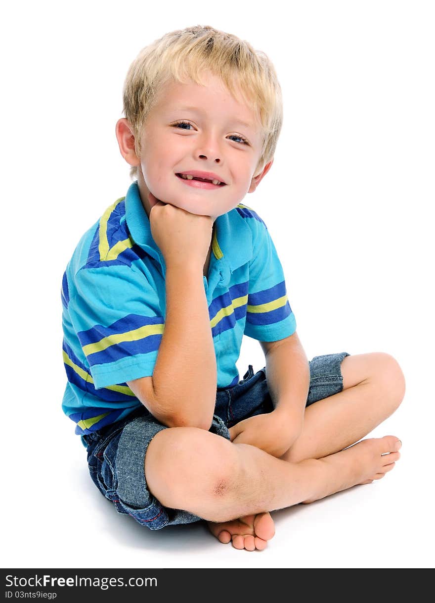 Young caucasian child sits cross legged, isolated on white. Young caucasian child sits cross legged, isolated on white