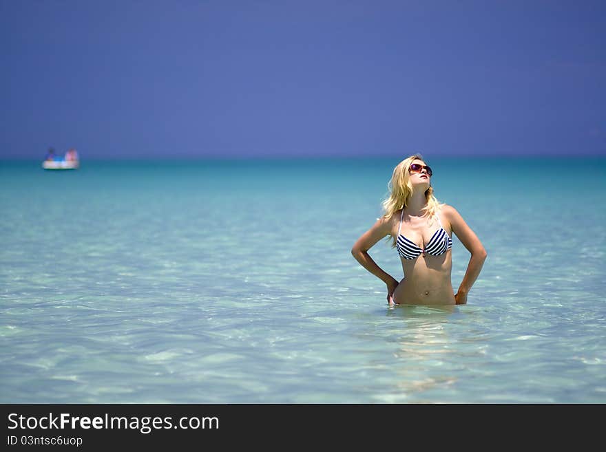 Sexy woman in sunglasses sunbathing in the sea. Sexy woman in sunglasses sunbathing in the sea