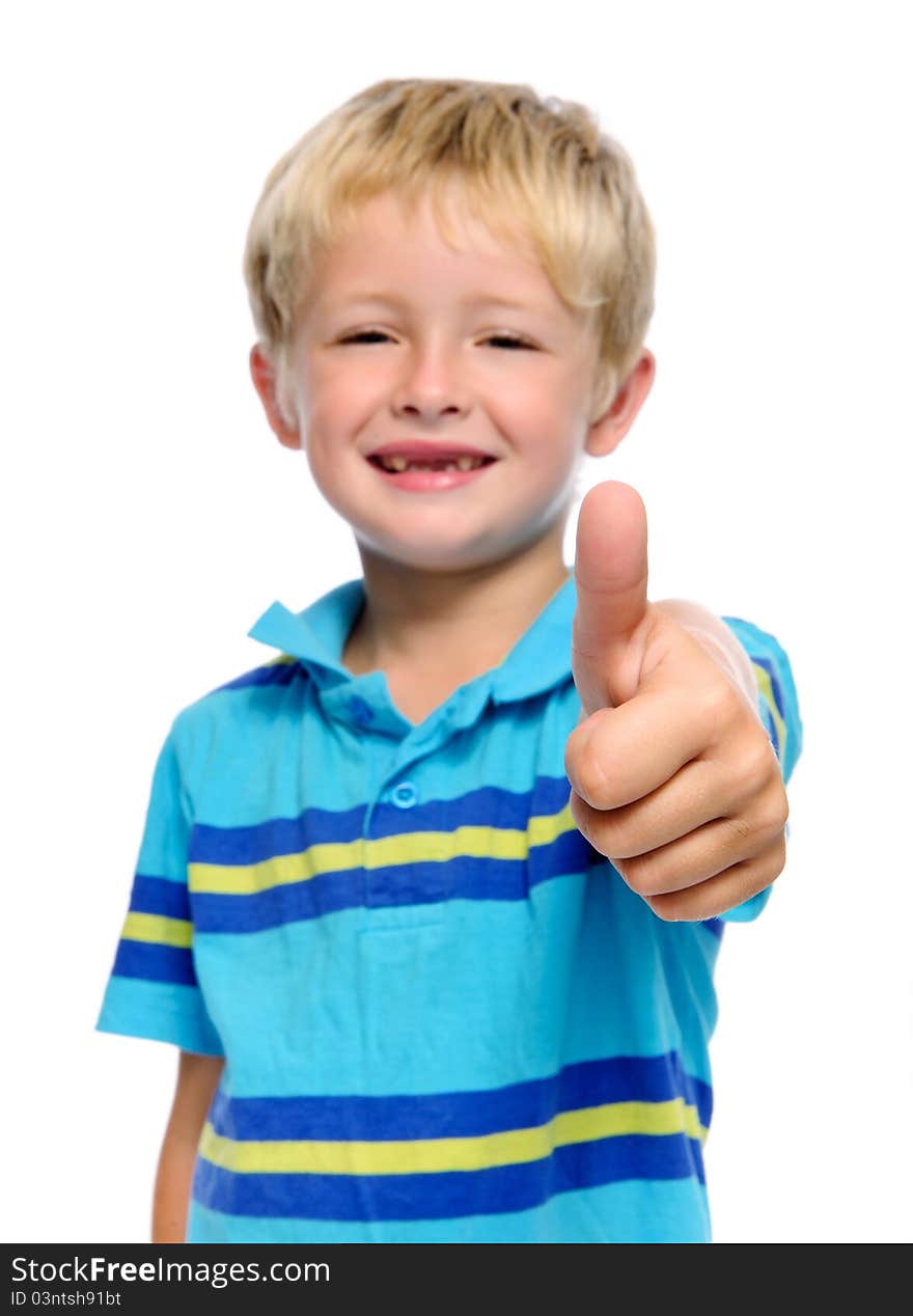 Happy young boy has his thumbs up; selective focus on hand. Happy young boy has his thumbs up; selective focus on hand