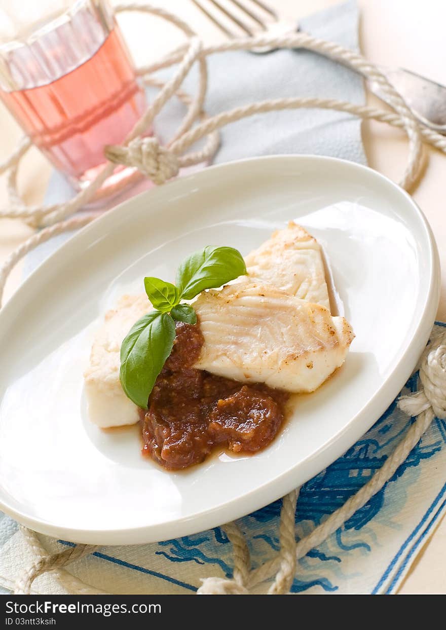 Fish fillet with sauce and basil for your healthy dinner