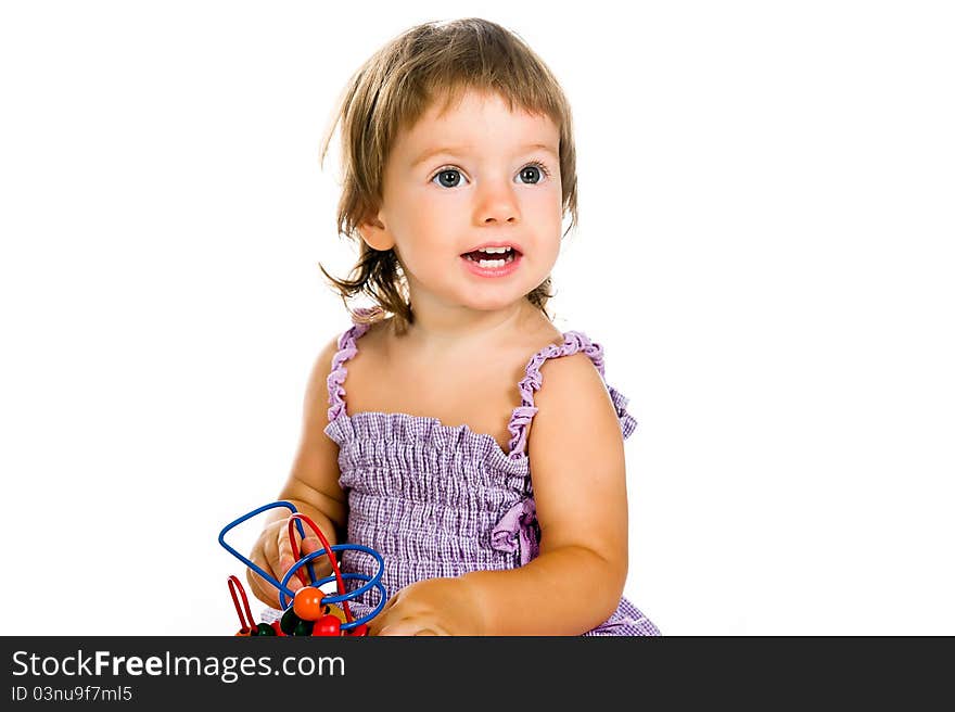 Small baby with developmental toy on a white background