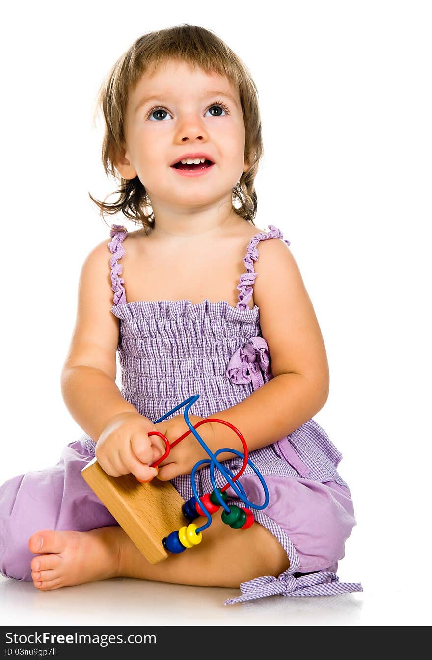 Small baby with developmental toy on a white background