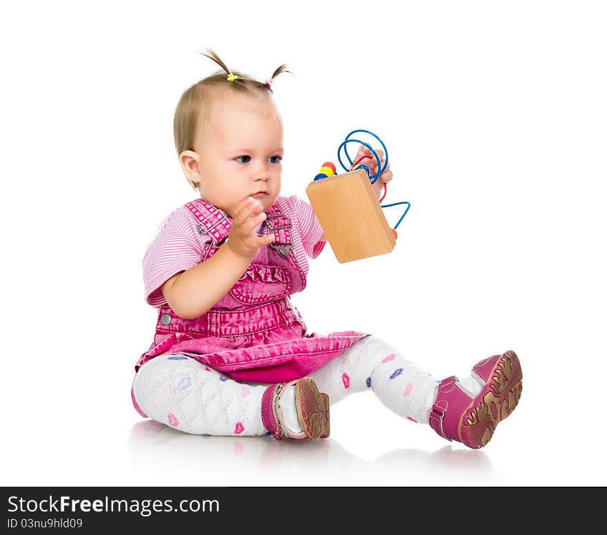 Small baby with developmental toy on a white background